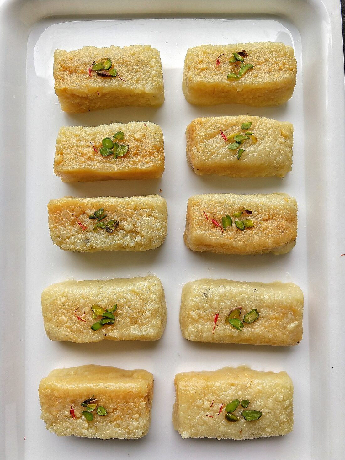 Tray of fresh milk barfi garnished with pistachio at Bhardwaj Sweets